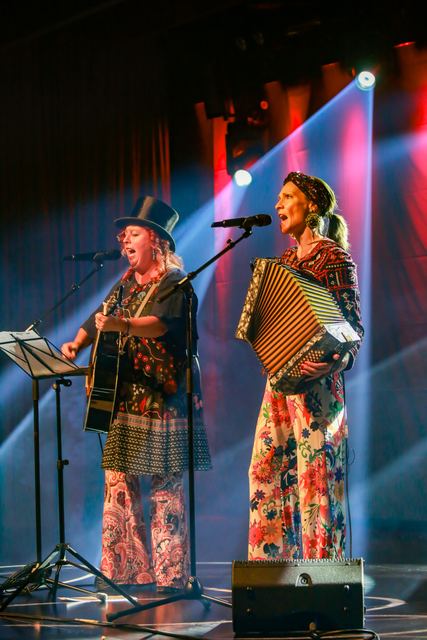 Die zwei Schrullen in bunten Hosen auf der Bühne, eine mit Gitarre, eine mit Akkordeon